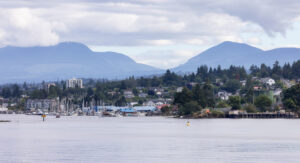 City by the water, Marina with Boats, surrounded by Homes, mountains and trees. Summer Season. Nanaimo, Vancouver Island, British Columbia, Canada. City Background.