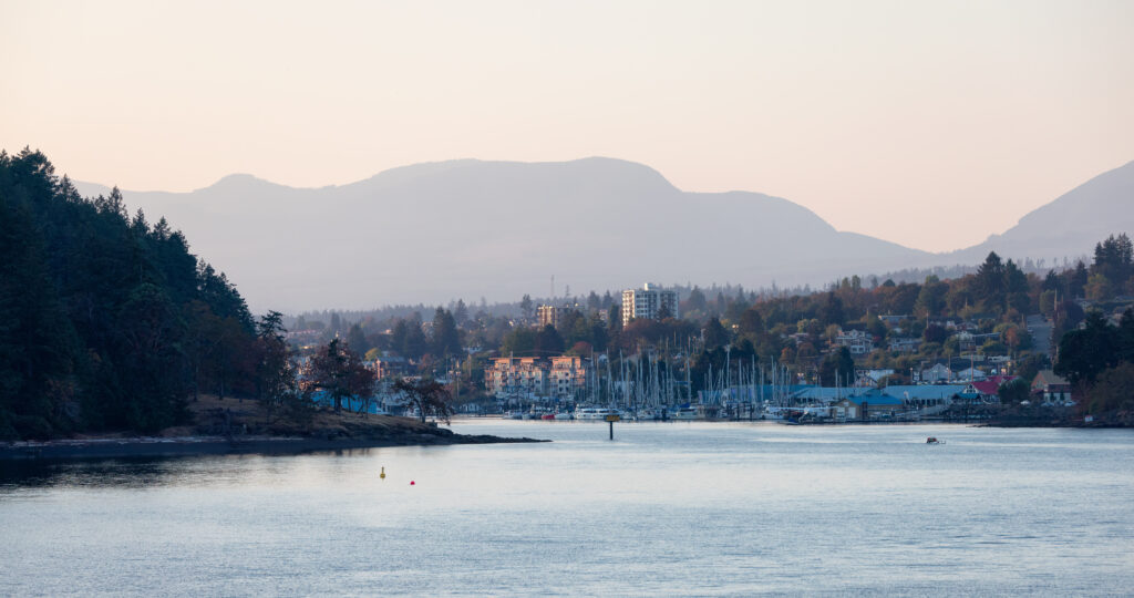 City by the water, Marina with Boats, surrounded by Homes, mountains and trees. Fall Season. Nanaimo, Vancouver Island, British Columbia, Canada. City Background.