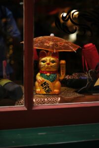 Lucky cat in the window of a shop in Chinatown, Victoria, BC
