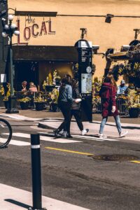 group of people walking across the street in downtown Victoria, BC
