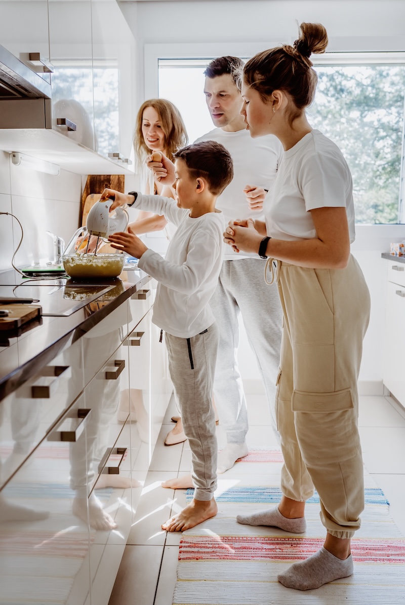 family in a bright home together - baking in the kitchen