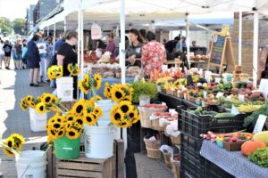 farm market with sunflowers in the forground