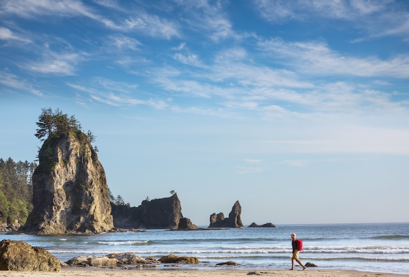 Hiker on the beach in ocean coast. Vancouver island, Canada