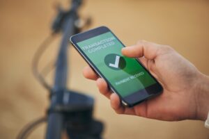 Hands, phone screen and payment notification for transaction, ecommerce or banking outdoor. Fintech.